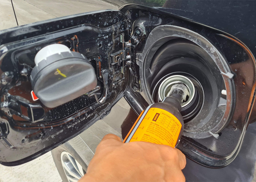gasoline additive being added to a vehicle