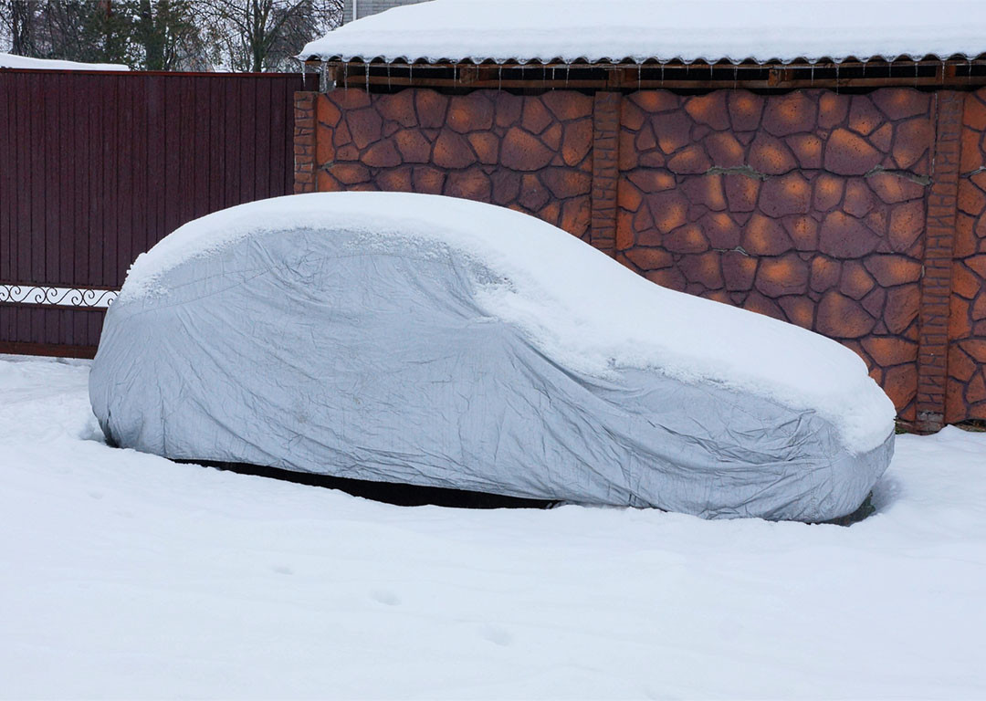 vehicle with a tarp covered in snow